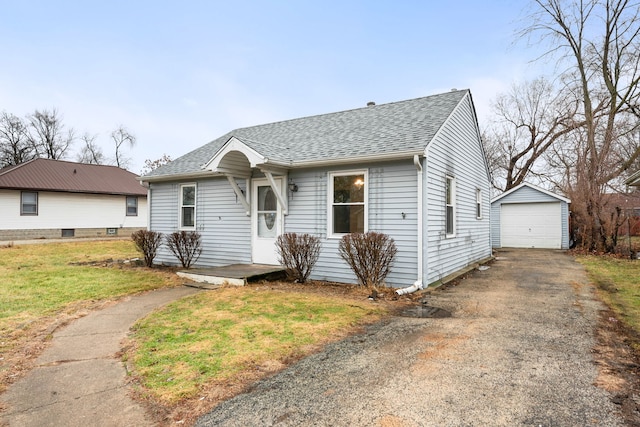 view of front of house with a garage, an outdoor structure, and a front lawn