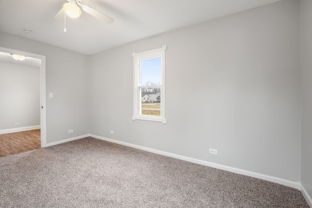 carpeted spare room with ceiling fan