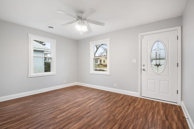 foyer entrance with dark wood-type flooring and ceiling fan