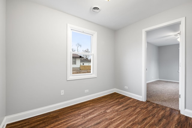 spare room with dark hardwood / wood-style floors