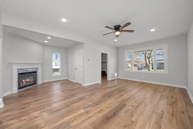 unfurnished living room with ceiling fan and light hardwood / wood-style floors