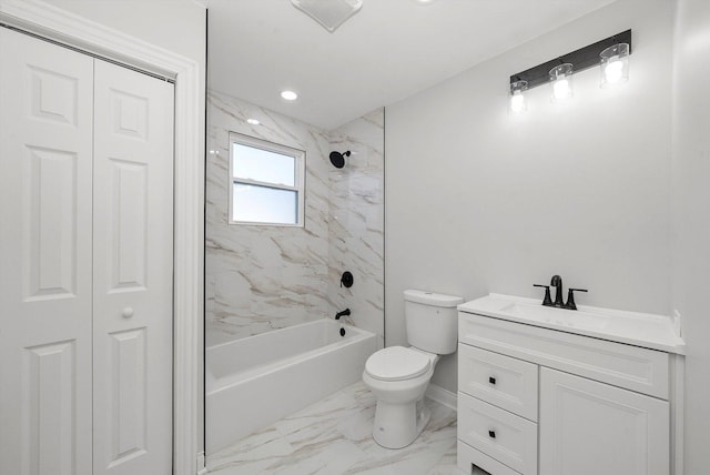 full bathroom featuring tiled shower / bath, vanity, and toilet