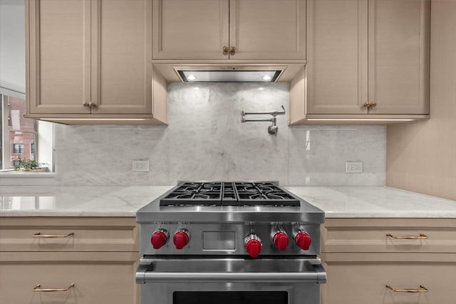 kitchen with ventilation hood, tasteful backsplash, light stone countertops, and stainless steel stove