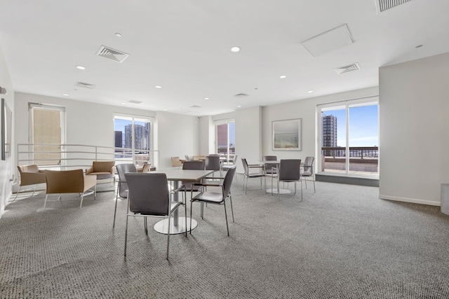 carpeted dining room with a healthy amount of sunlight