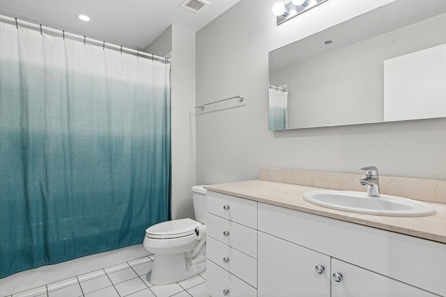 bathroom with tile patterned floors, vanity, and toilet