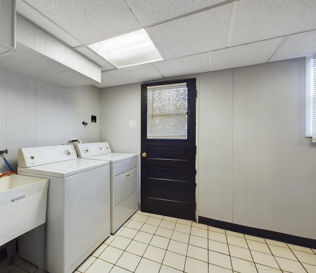 washroom featuring sink, washing machine and dryer, and light tile patterned floors