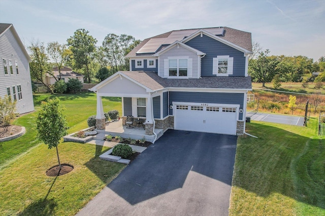 craftsman inspired home with a porch, a garage, and a front yard