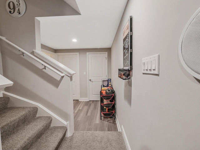 staircase with hardwood / wood-style floors