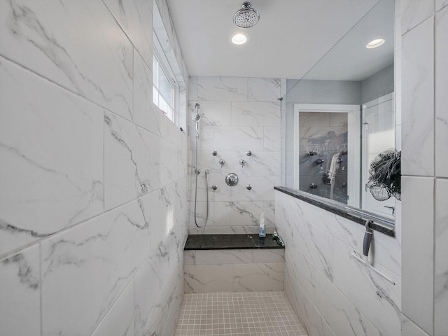 bathroom with tile walls and a tile shower