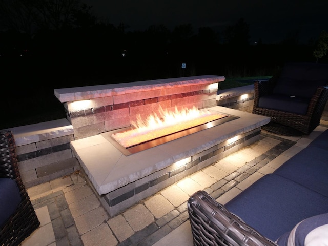 patio at twilight featuring an outdoor kitchen