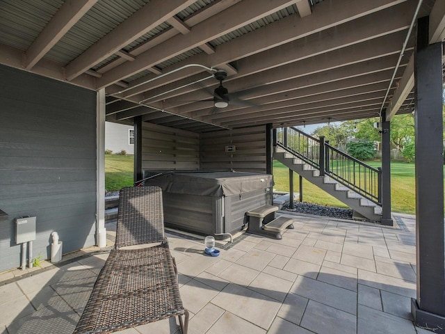 view of patio / terrace featuring ceiling fan and a hot tub