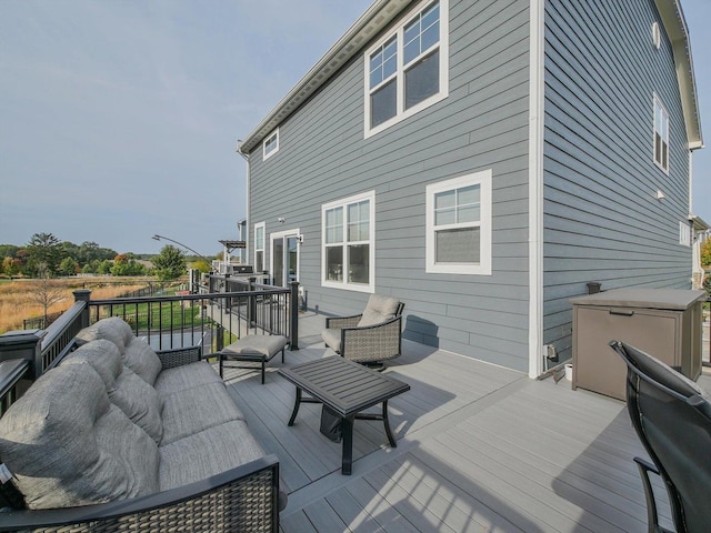 wooden terrace featuring outdoor lounge area