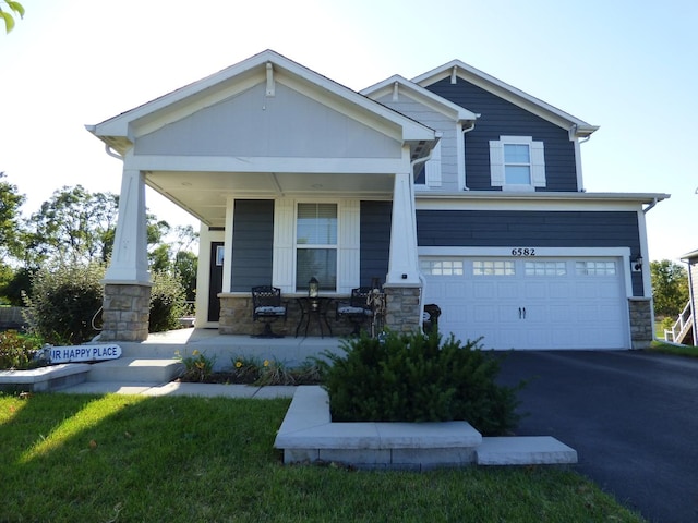 craftsman-style home with a porch and a garage