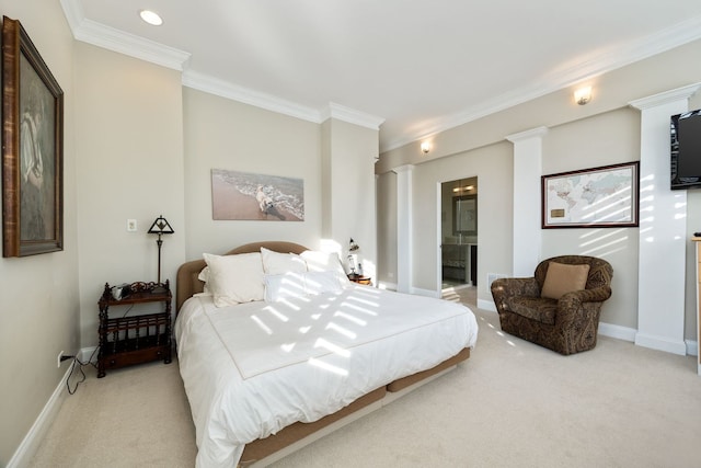 carpeted bedroom with crown molding, connected bathroom, and decorative columns