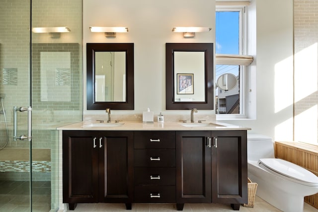 bathroom featuring an enclosed shower, vanity, plenty of natural light, and toilet