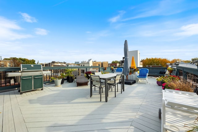 wooden deck featuring a grill