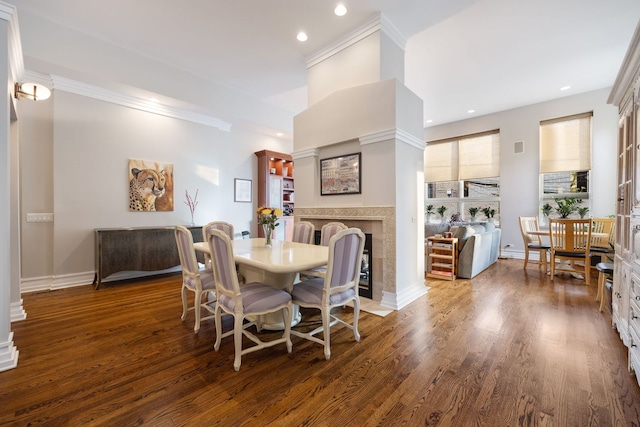 dining area featuring ornamental molding and dark wood-type flooring