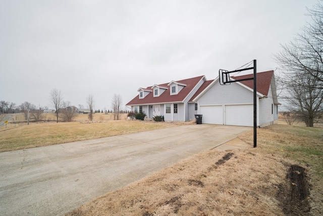 view of front of home with a garage and a front lawn