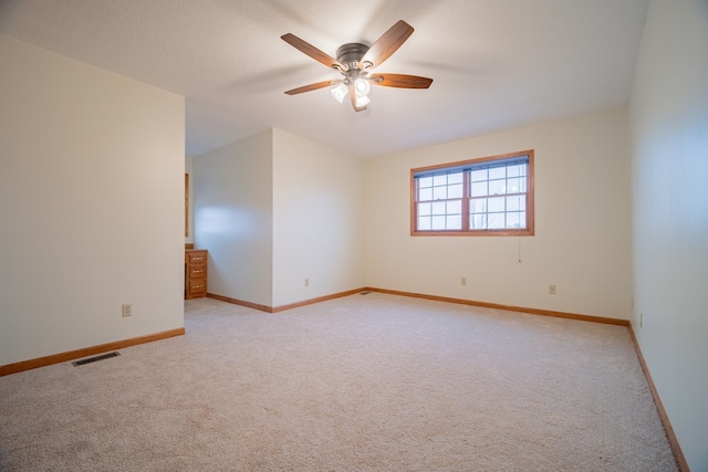 empty room with light carpet and ceiling fan