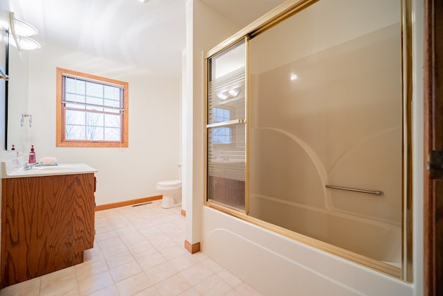 full bathroom featuring vanity, tile patterned floors, combined bath / shower with glass door, and toilet