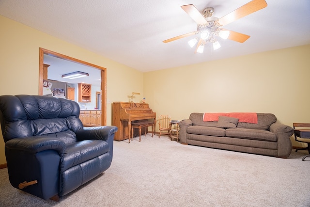 carpeted living room with ceiling fan