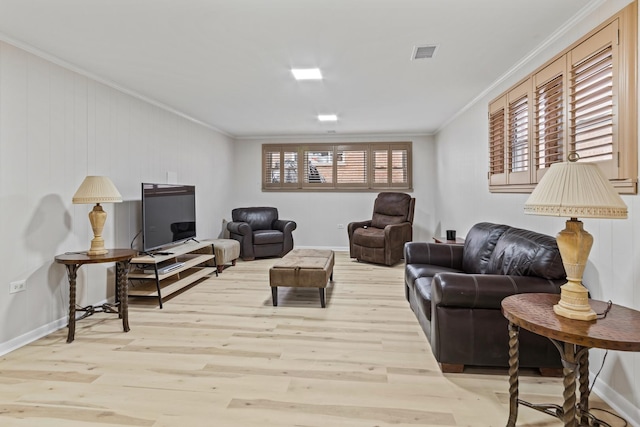 living room featuring crown molding and light hardwood / wood-style flooring