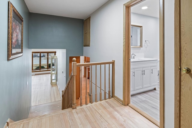 hall featuring sink and light wood-type flooring