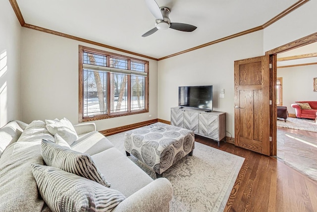 living room featuring crown molding, ceiling fan, and dark hardwood / wood-style floors