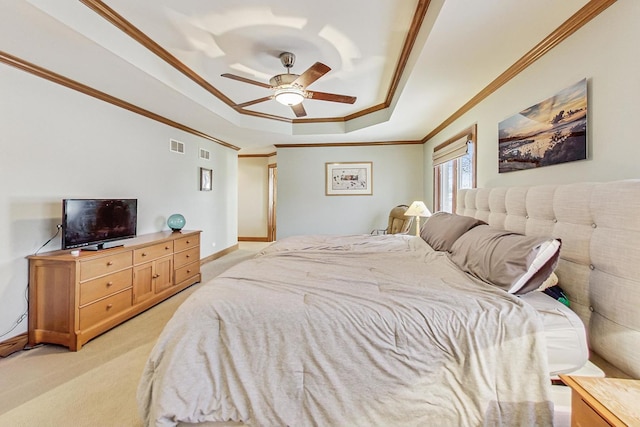 carpeted bedroom featuring ornamental molding, a raised ceiling, and ceiling fan