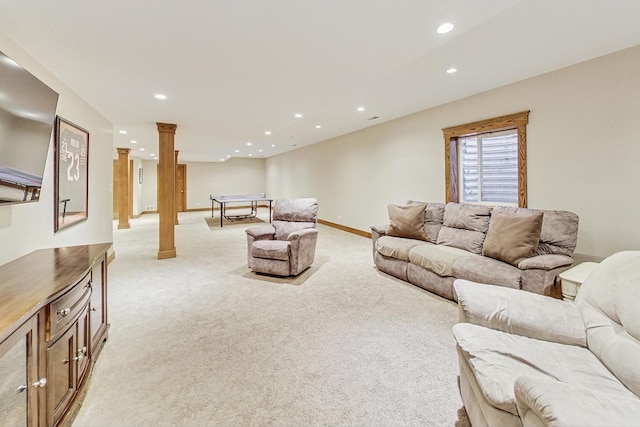 carpeted living room featuring ornate columns