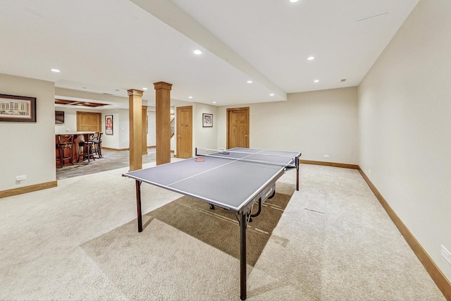 game room featuring bar, light colored carpet, and decorative columns