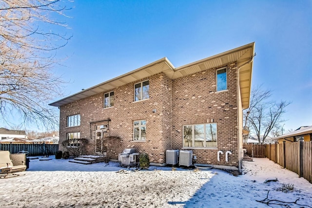 snow covered property featuring cooling unit