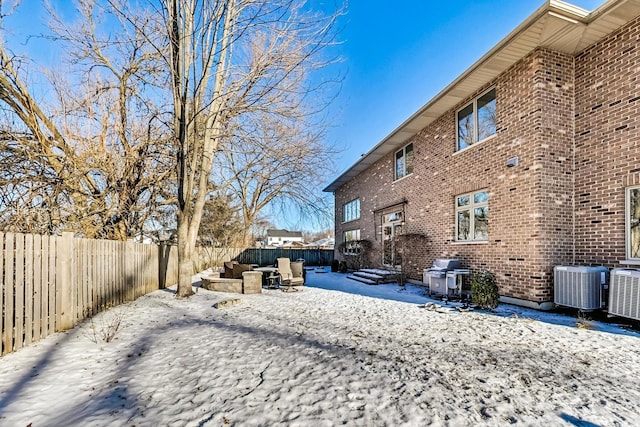 yard covered in snow with central AC