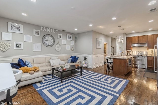 living room with dark hardwood / wood-style flooring