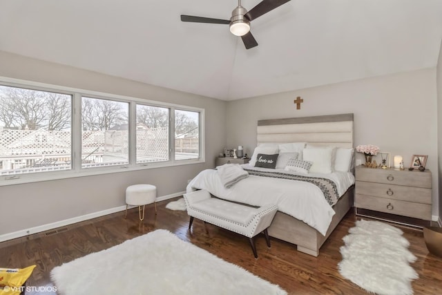 bedroom featuring vaulted ceiling, dark hardwood / wood-style floors, and ceiling fan