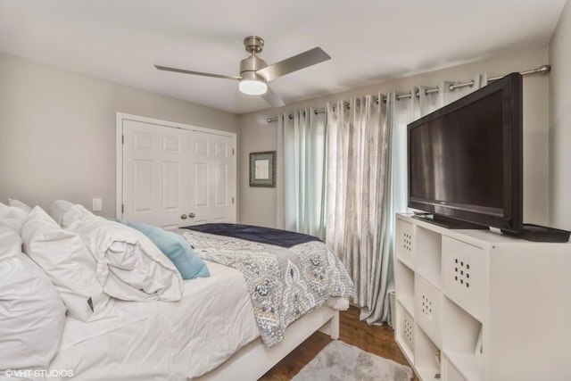 bedroom featuring ceiling fan, wood-type flooring, and a closet