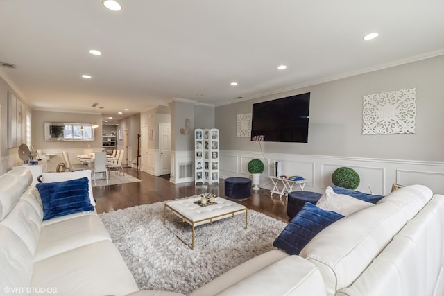 living room with dark wood-type flooring and ornamental molding