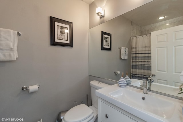 bathroom with vanity, walk in shower, and toilet