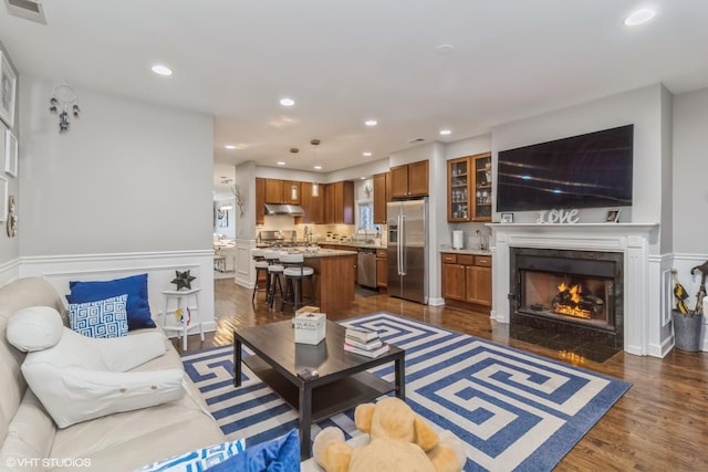 living room featuring dark hardwood / wood-style floors and a fireplace