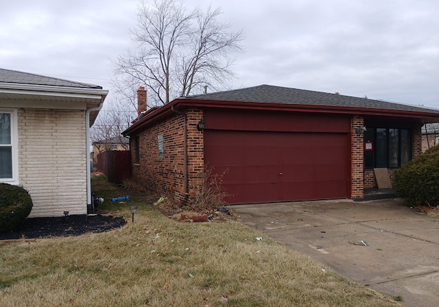 view of home's exterior with a garage and a yard