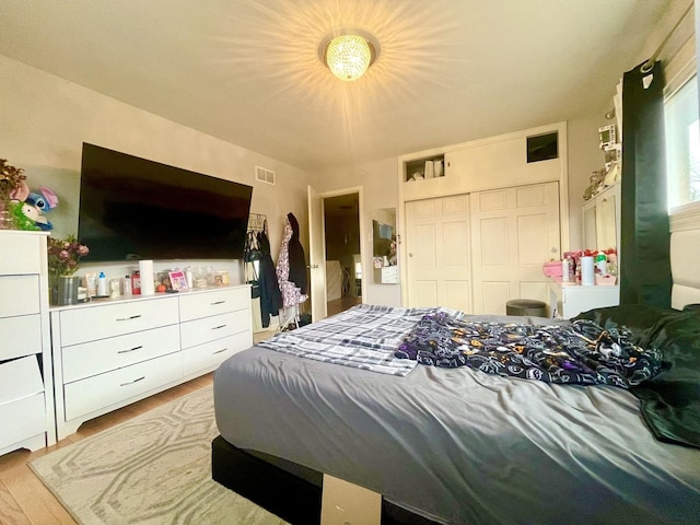 bedroom featuring a closet and light hardwood / wood-style flooring