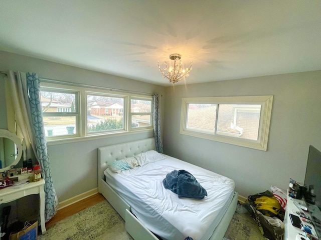 bedroom featuring a chandelier and light hardwood / wood-style flooring