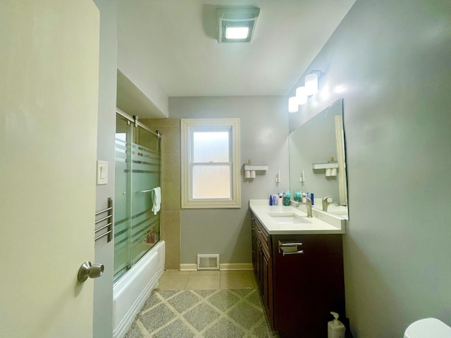 bathroom featuring enclosed tub / shower combo, vanity, and tile patterned floors