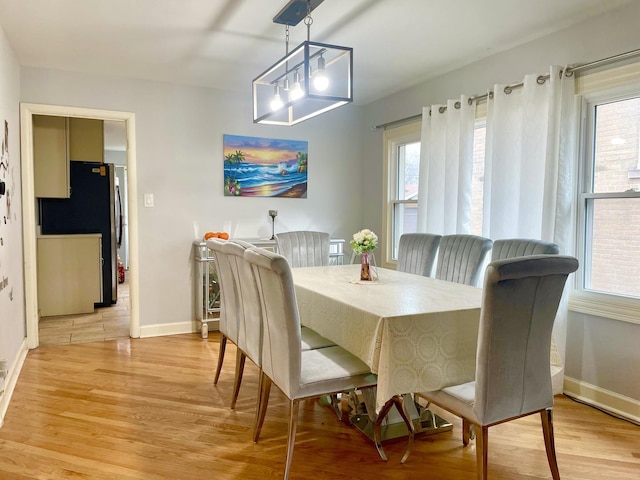 dining area featuring a chandelier and light hardwood / wood-style flooring