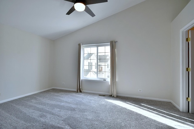 spare room featuring carpet, vaulted ceiling, and ceiling fan