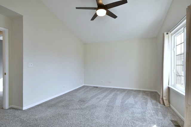 carpeted spare room featuring lofted ceiling, ceiling fan, and a healthy amount of sunlight