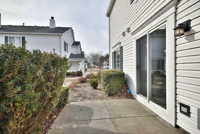 view of side of property with a patio