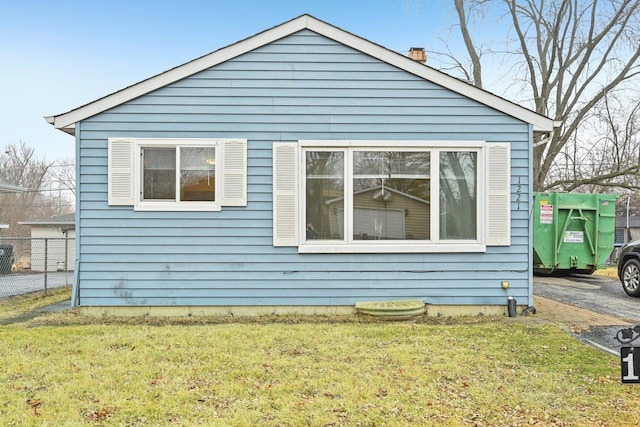 view of property exterior with a lawn