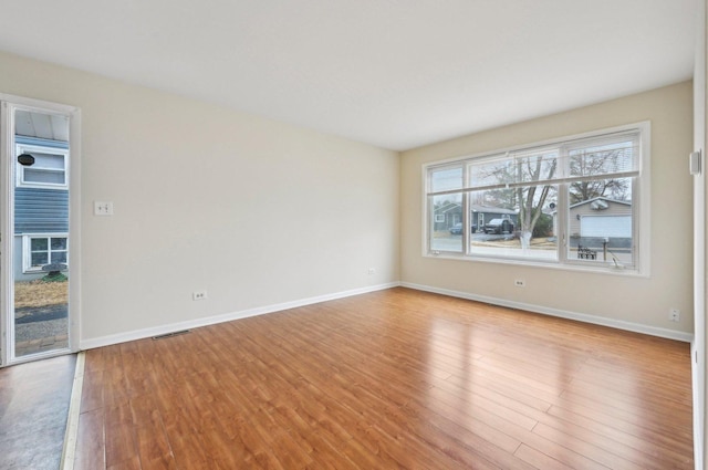 unfurnished room with light wood-type flooring