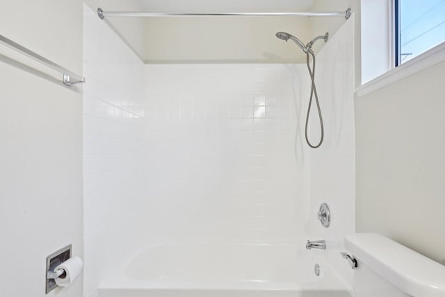 bathroom featuring toilet and bathing tub / shower combination